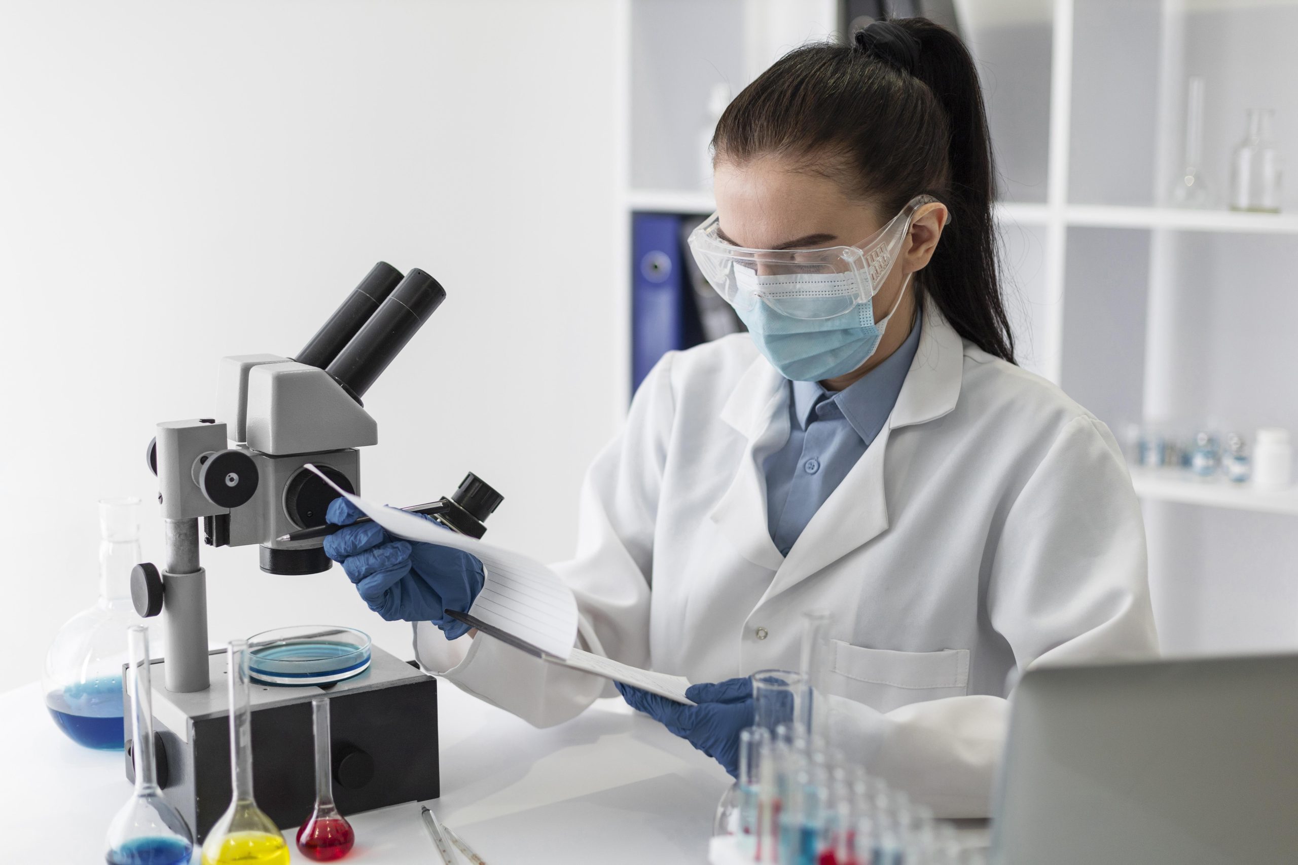 An image of a woman using a microscope for functional medicine testing for food sensitivities, digestive issues, infertility, hormones, Lyme and mold. This holistic approach to diagnosis and treatment can help uncover underlying health issues and create personalized treatment plans for patients.